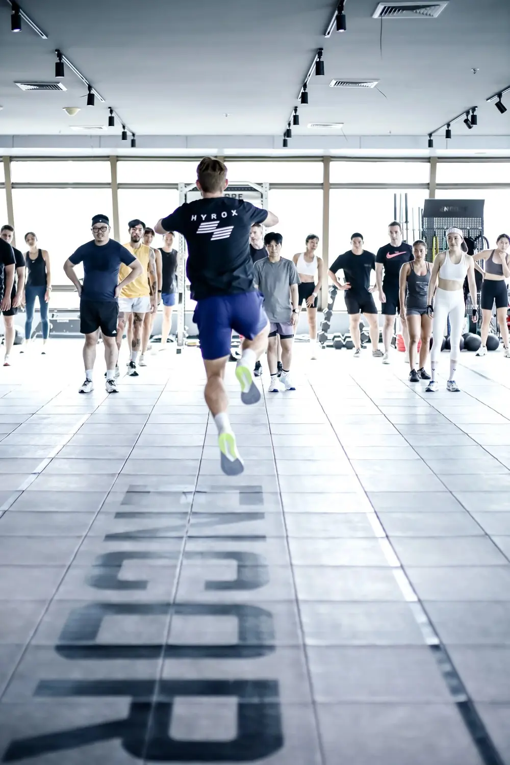 An Encore class on the gym floor, the coach leading from the front