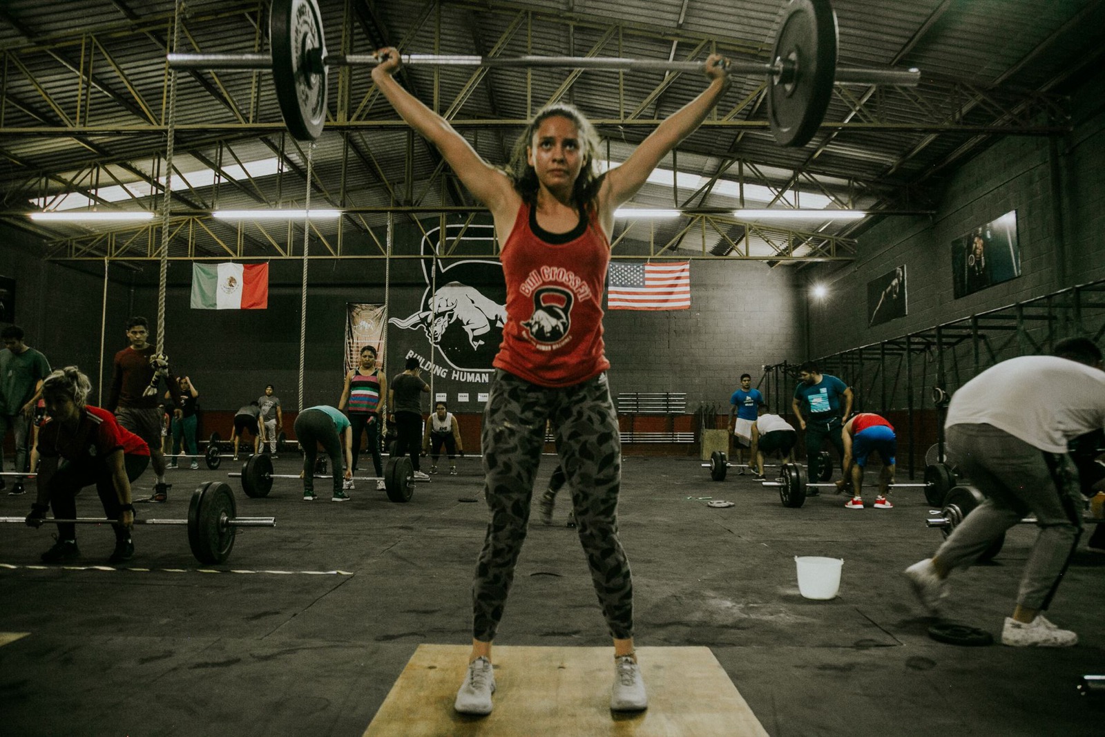 An athlete locking out an overhead press at the end of a session